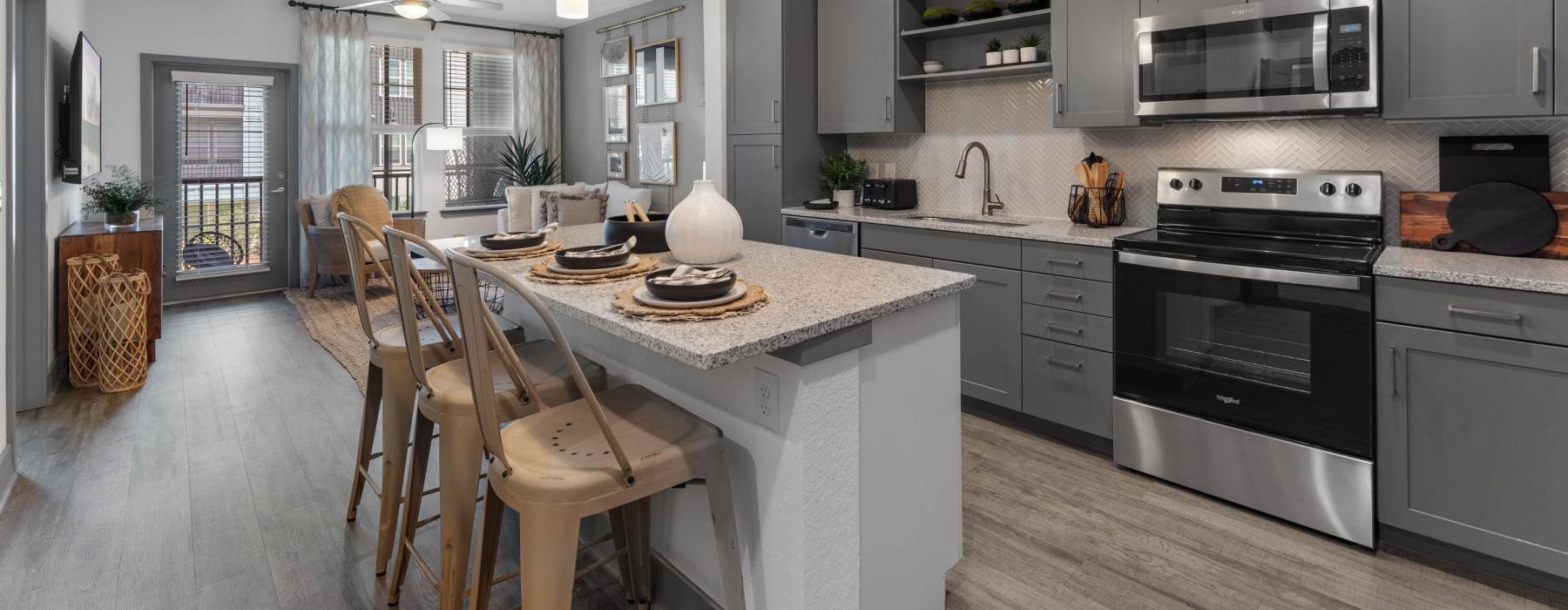 well lit kitchen open to living room