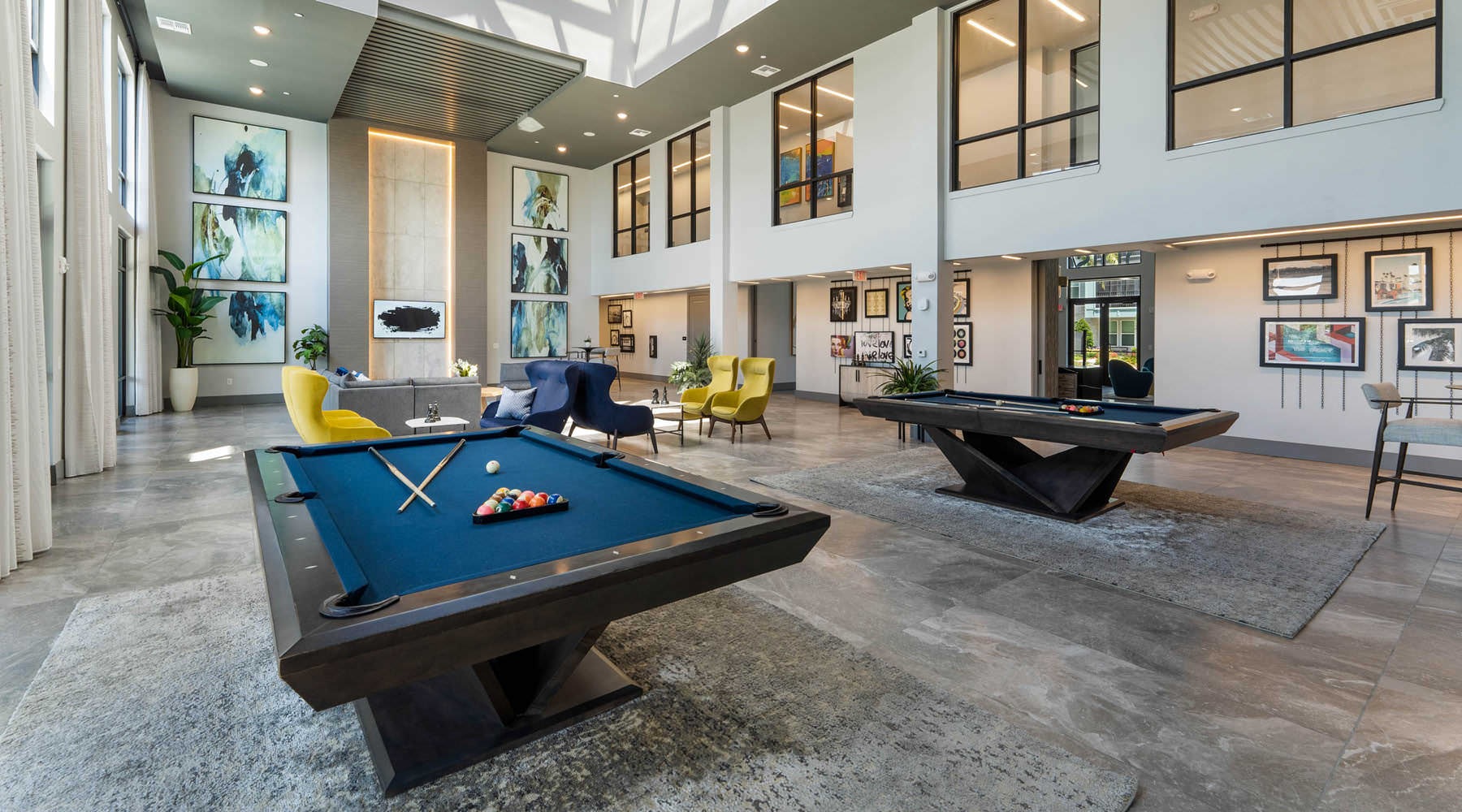 game room with pool tables and chairs