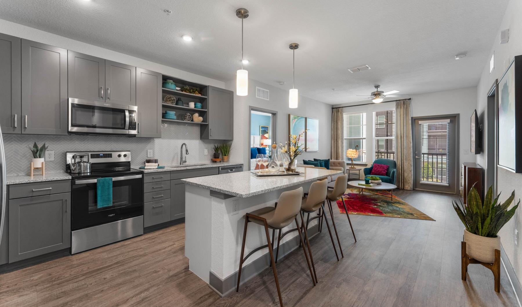 a kitchen with stools at island