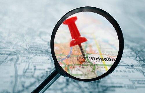 Closeup of a red tack in a map of Orlando Florida