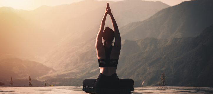 Lady doing Yoga Pose on mountains
