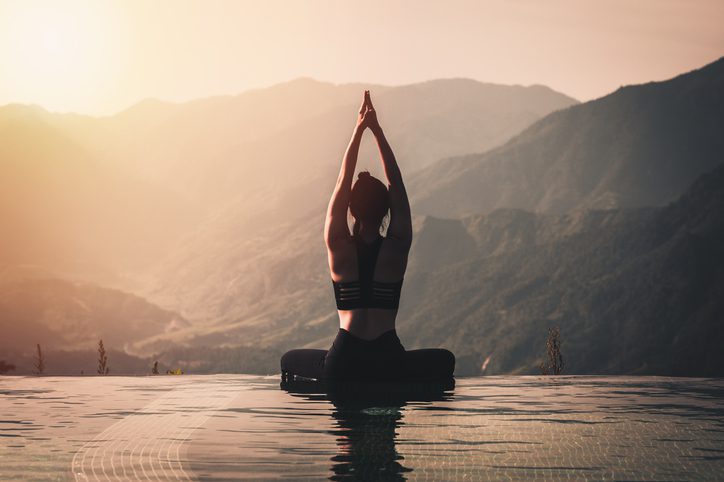 Lady doing Yoga Pose on mountains