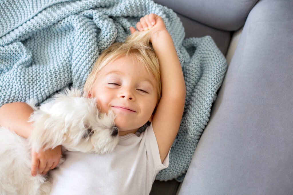 Young child with white dog