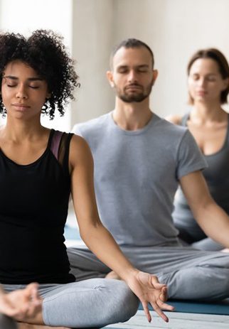 Three adults in yoga class